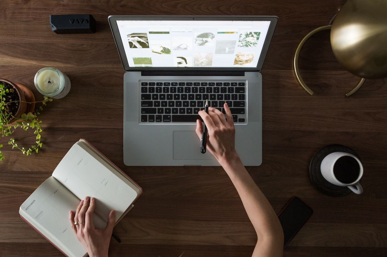 Mastering the First Impression: Your intriguing post title goes here An overhead shot of a desk setup featuring a laptop, notebook, pen, and coffee cup, ideal for work and productivity themes.